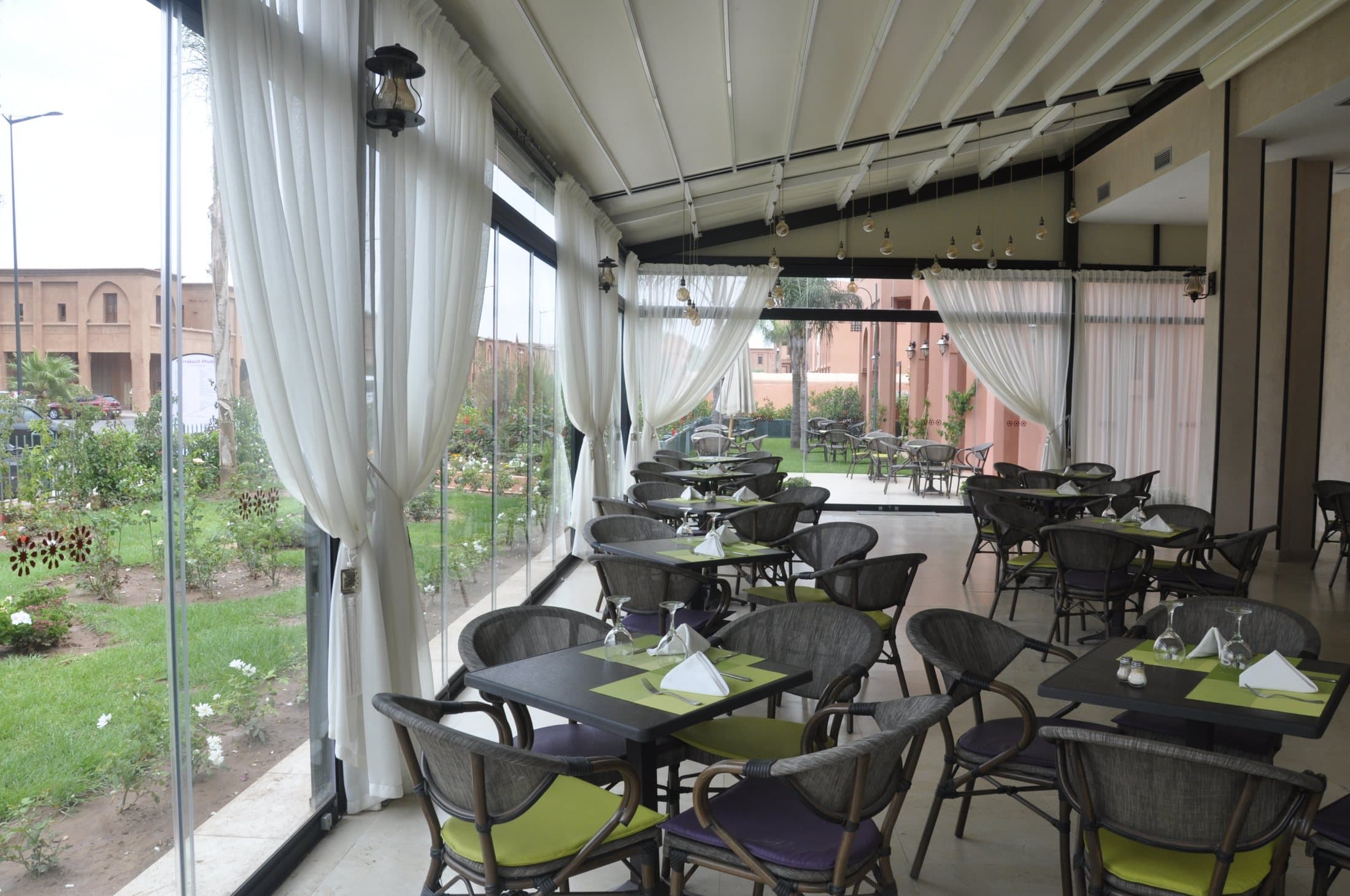 The bright veranda dining room overlooking the gardens